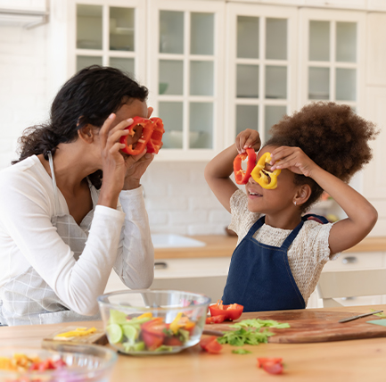 mom and daughter playing in the kitchen